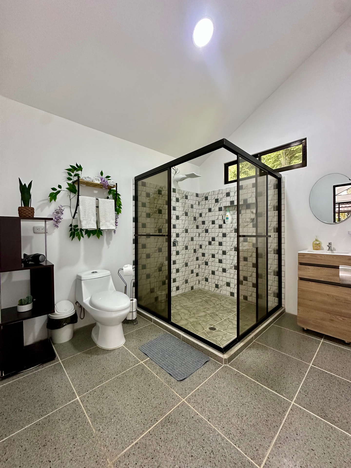 Spacious modern bathroom with walk-in shower and natural light